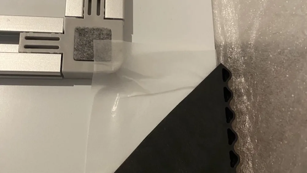 Close-up of a piece's protective packaging · corner foam and film